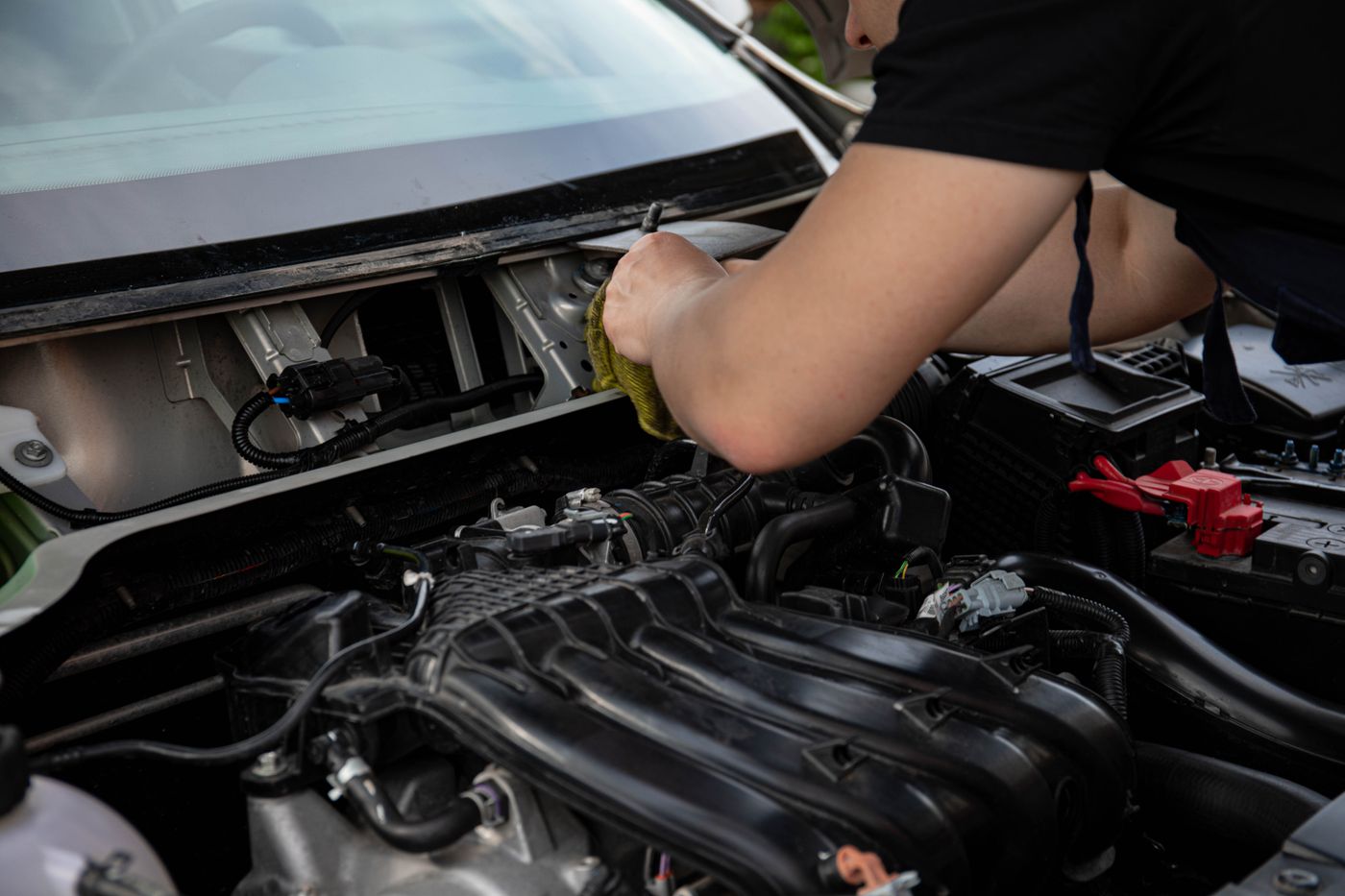 Mechanic completing engine maintenance during a car service